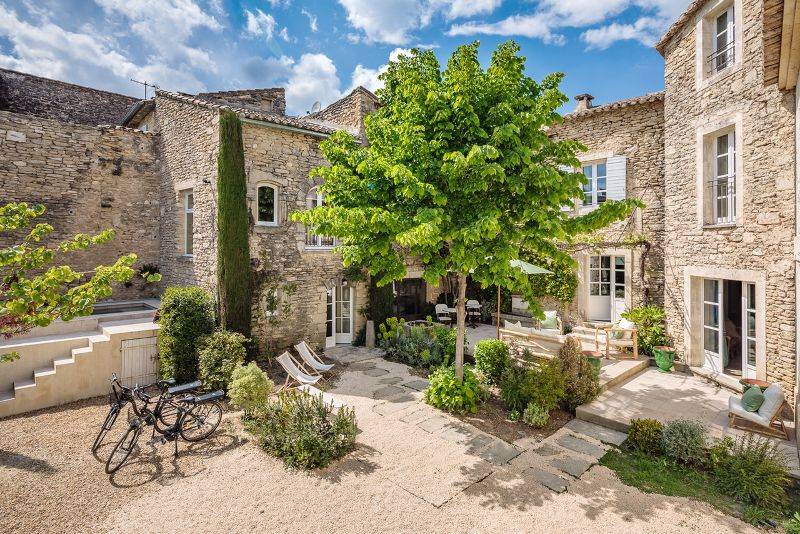 À Gordes, au cœur d’un hameau prisé, superbe maison en pierre du XVIIIe restaurée avec deux annexes dans un jardin clos avec bassin.