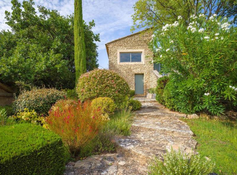 Gordes, belle propriété en pierres avec dépendance, piscine et terrasses, offrant des vues panoramiques sur le Luberon.