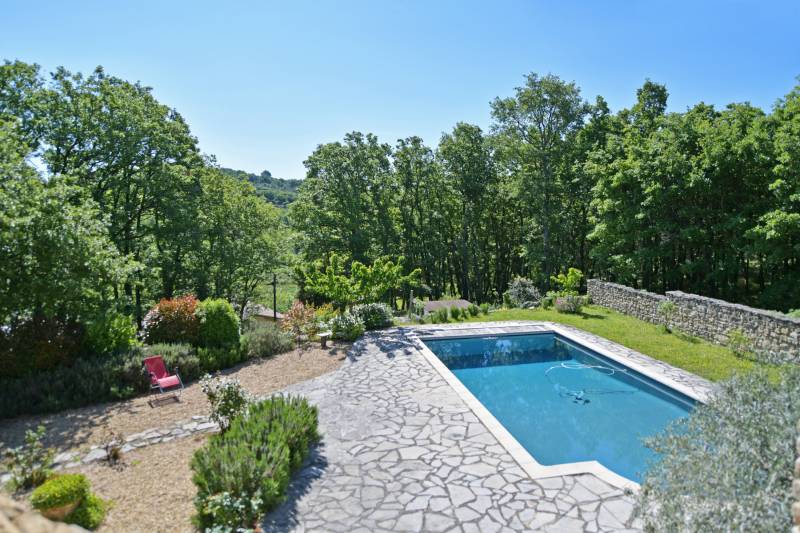 Murs: maison en pierres avec piscine et jardin paysagé dans la campagne, à quelques km de Gordes.