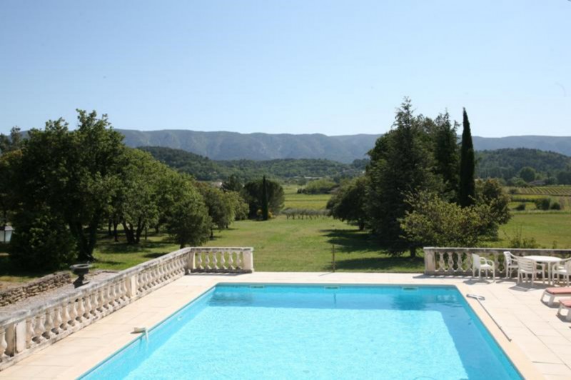 For sale, provencal property with pool and terrace overlooking a vineyard, countryside and facing the Luberon